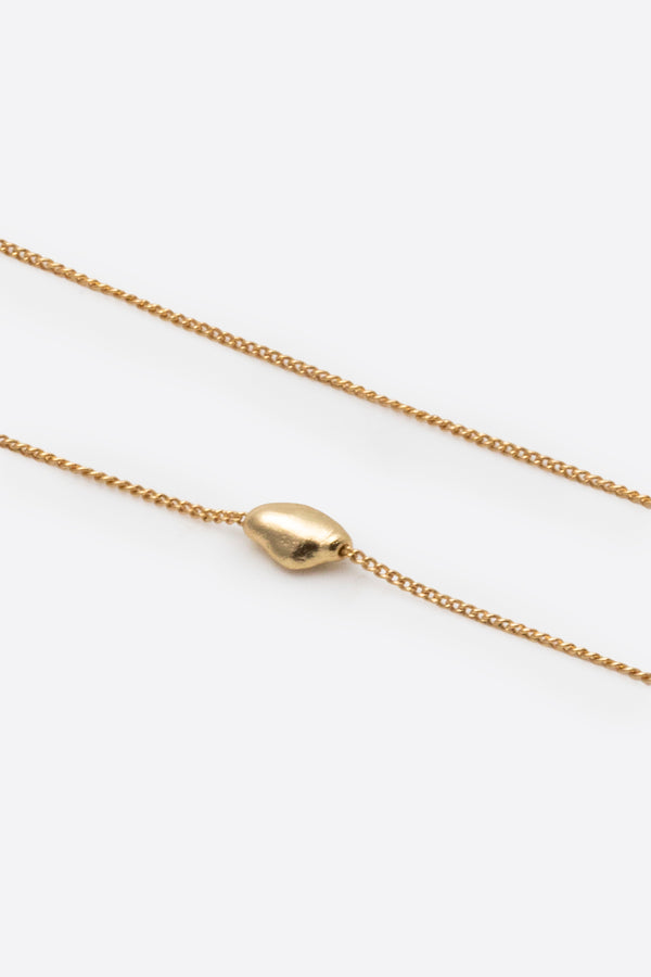 Gold pendant necklace showing chain and adjustable slider detail