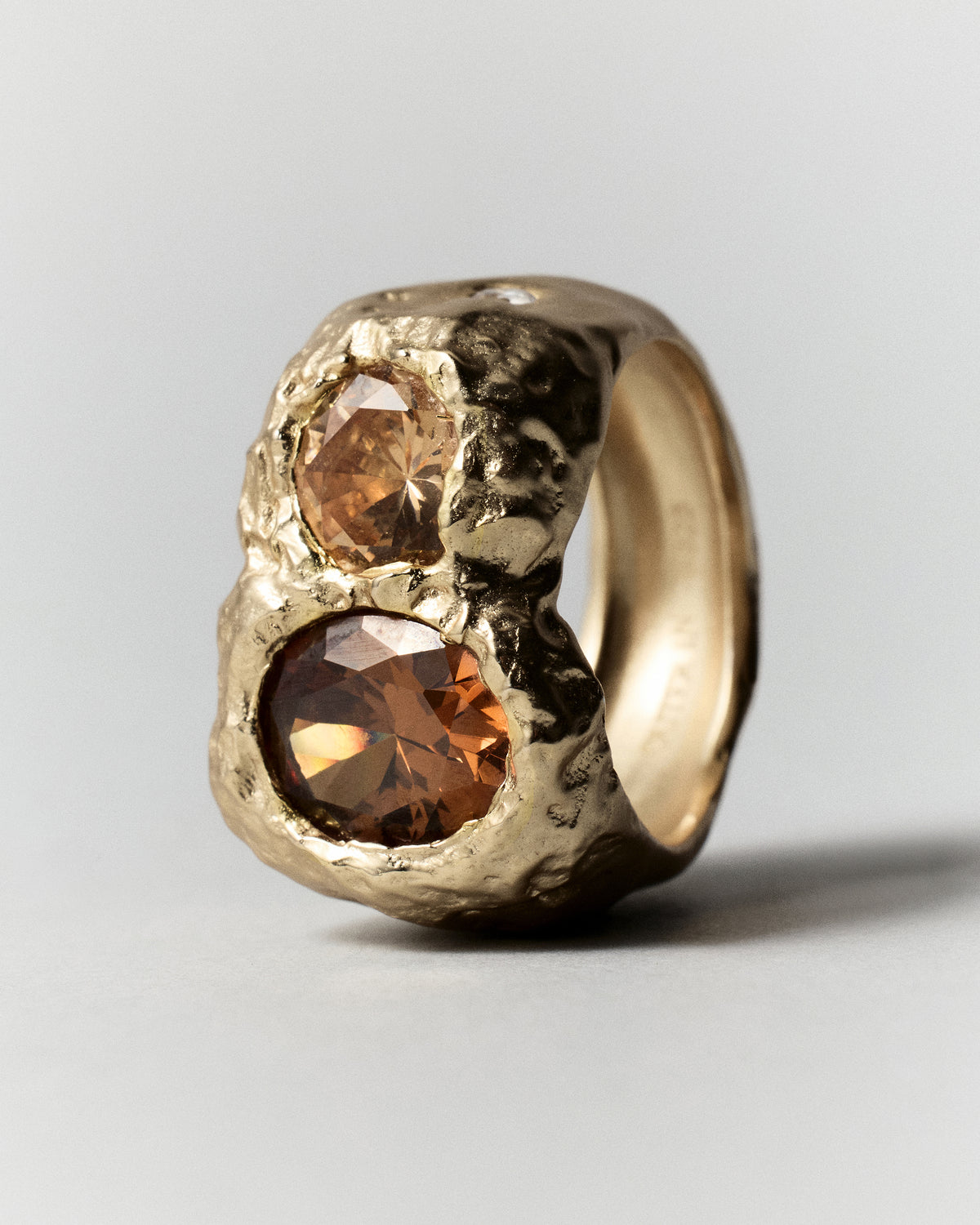 Cocoon Ring in gold: side view of the wide textured ring and raised stones.