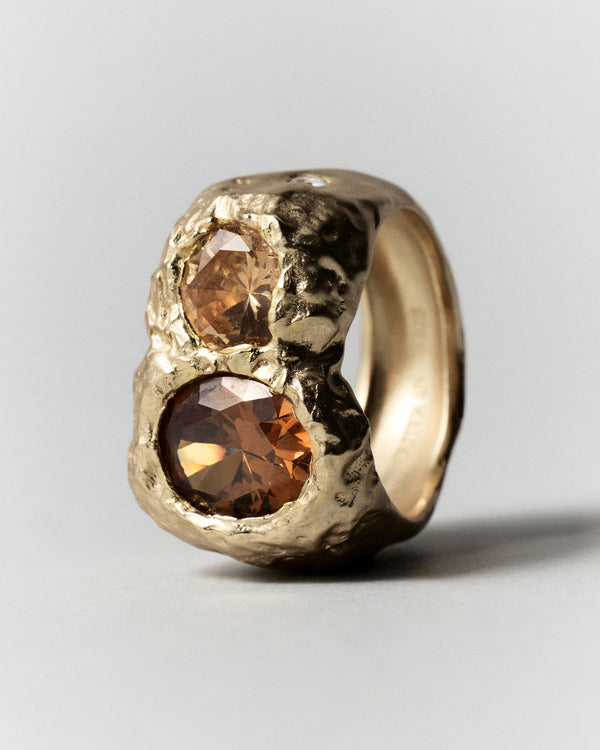 Cocoon Ring in gold: side view of the wide textured ring and raised stones.