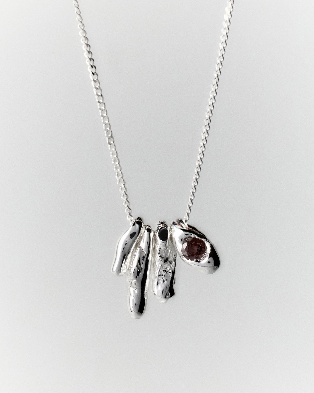 Dolomitas Necklace in silver: full view of the necklace's clustered pendants and reddish stone.