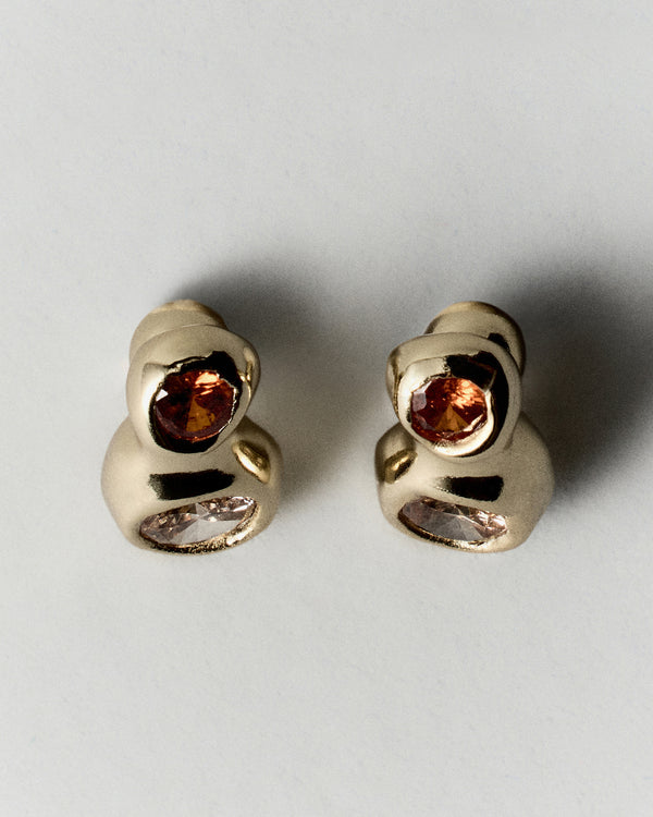 Double Pepita Studs Earrings in gold: side view showing the double-stone studs' sculptural curved settings.