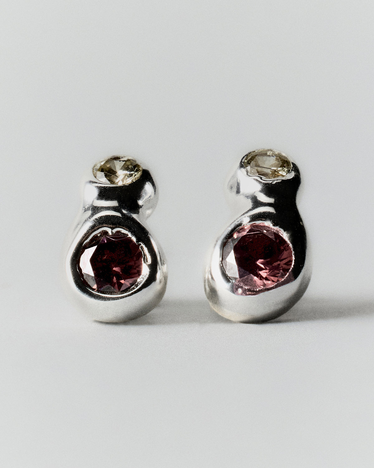Double Pepita Studs Earrings in silver: pair of double-stone stud earrings with pale and dark reddish stones.