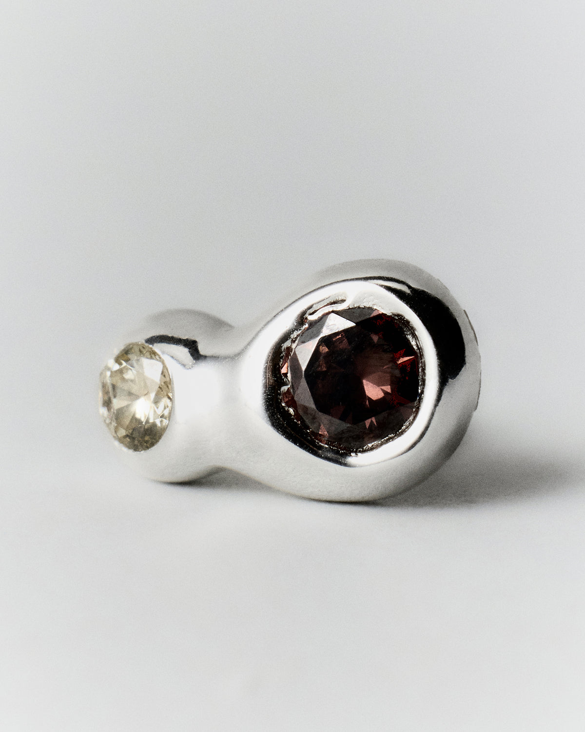 Double Pepita Studs Earrings in silver: close-up showing the two contrasting stones on a stud earring.