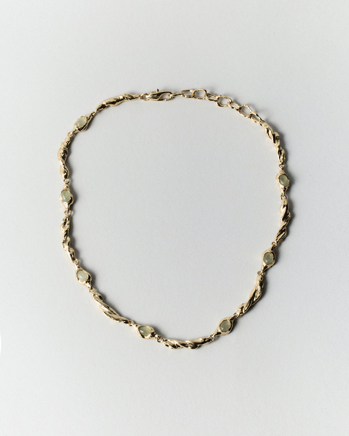 Dunestone Necklace in gold: full necklace with organic textured links on white.