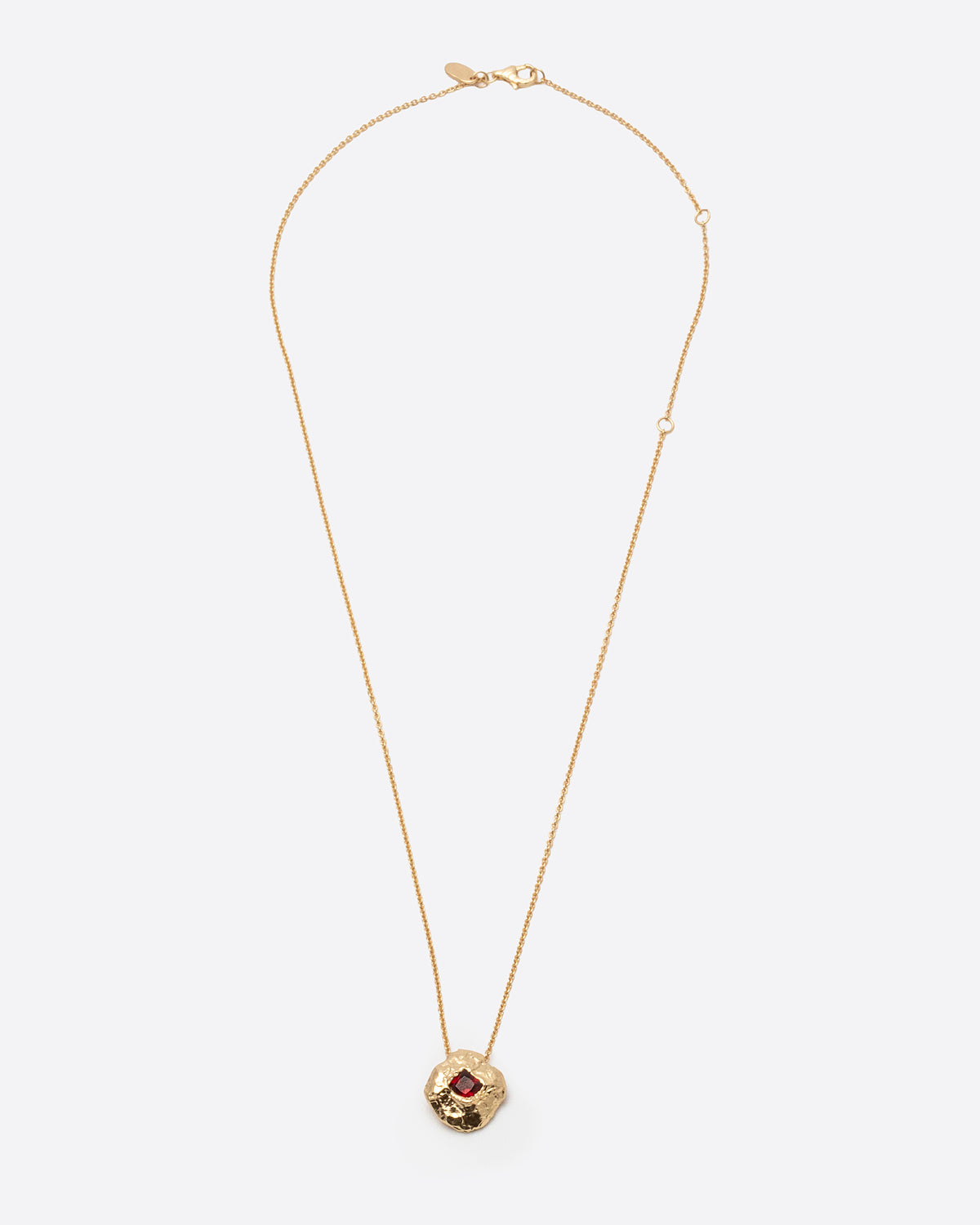 Helios Necklace in gold: full-length view of the fine chain and small round pendant.
