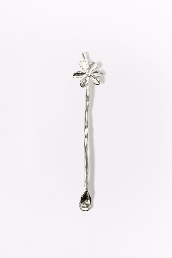 Silver strring stick with floral design on a white background