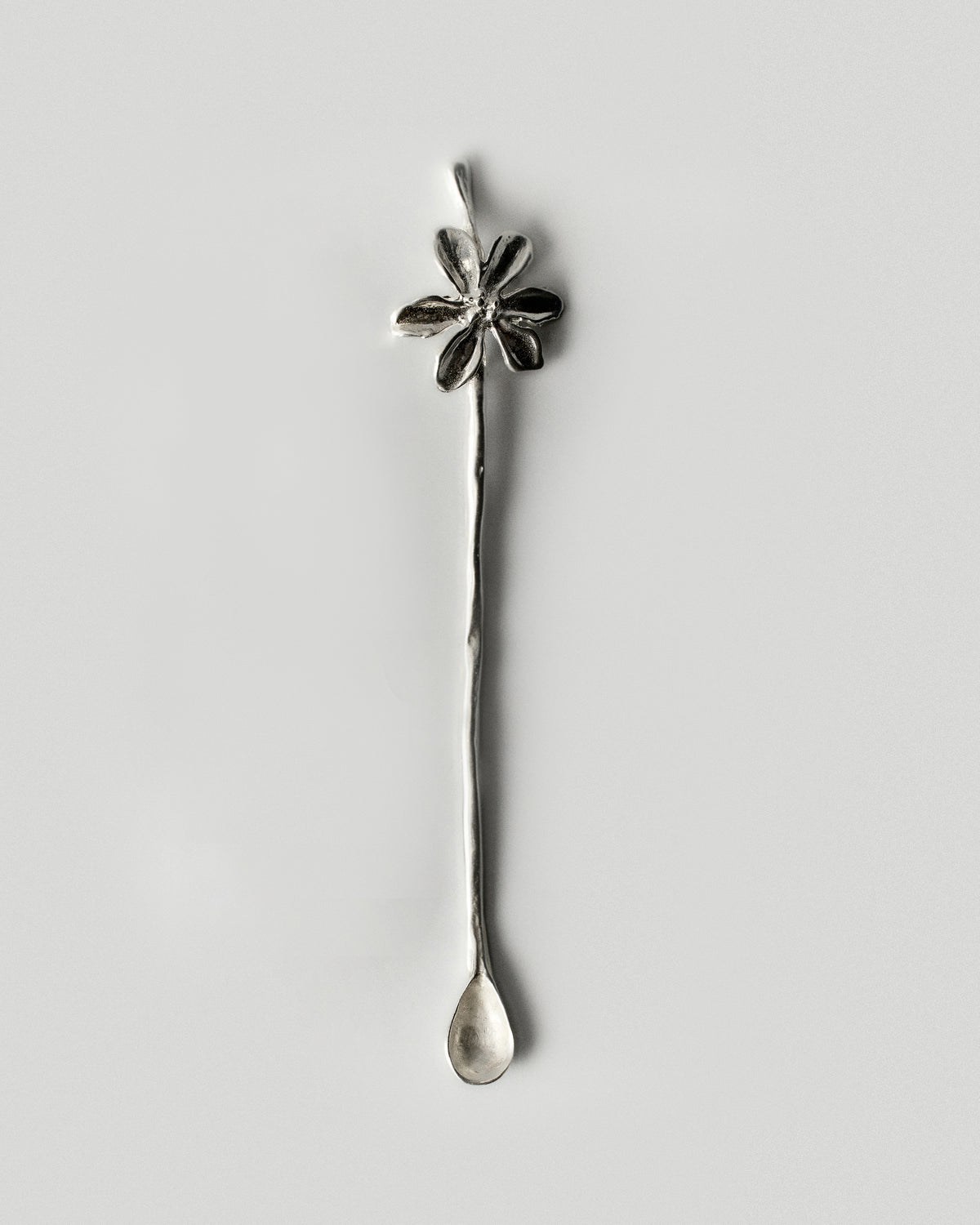 Iris Bloom Cutlery Spoon, Stirring Stick in silver: full view of the flower-handled stirring stick.
