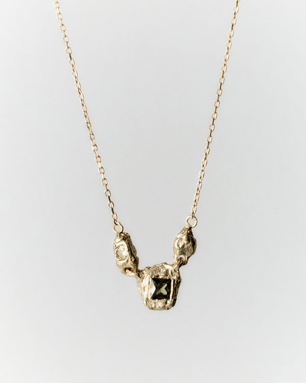 Juno Necklace in gold: necklace with small irregular links and inset stones at the center.