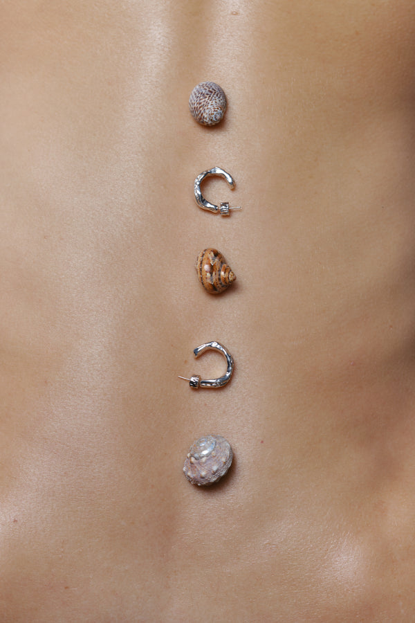 Layered Earth Hoop Earrings in silver: silver and gold hoop earrings styled with small stones.