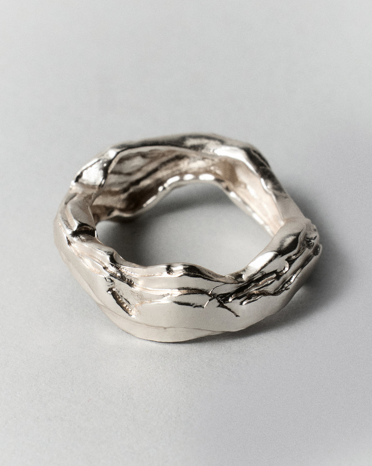 Layered Earth Ring in silver: overhead angled view of the irregular ring opening.