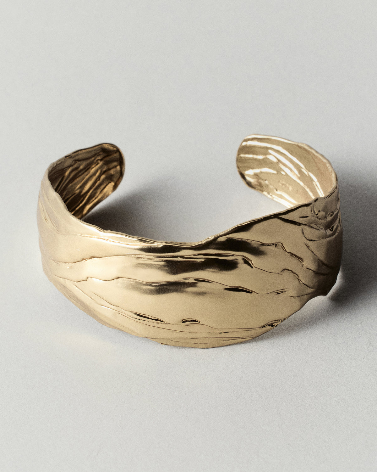 Layered Earth Statement Cuff in gold: angled view of the broad open cuff.