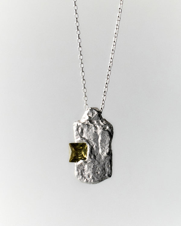 Nova Necklace in silver: textured vertical pendant with a yellow-green rectangular stone.