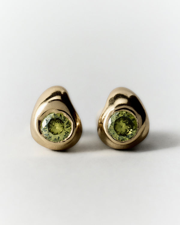 Pepita Studs Earrings in gold: pair of rounded stud earrings with green stones.