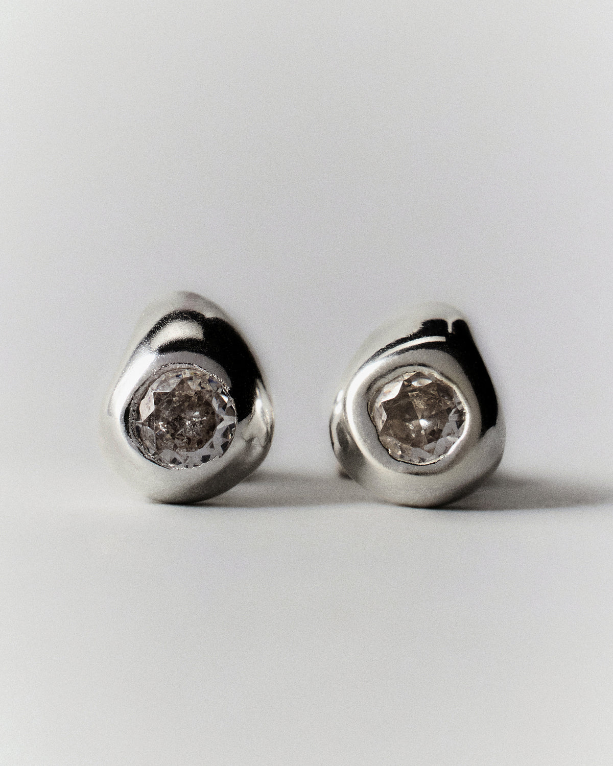 Pepita Studs Earrings in silver: pair of rounded stud earrings with pale stones.