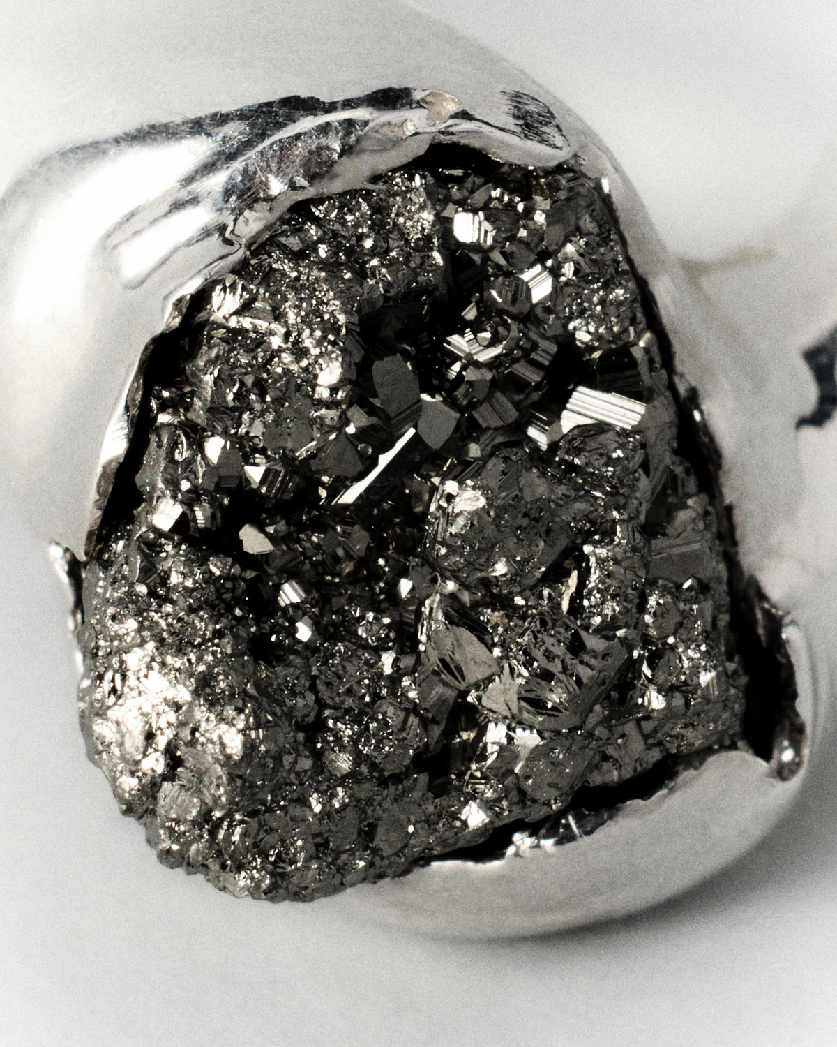Pirita Ring in silver: extreme close-up of the stone's dark glittering crystalline surface.