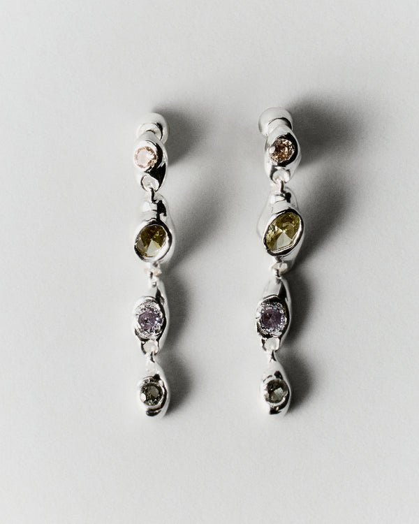 Prado Pepita Long Earrings in silver: pair of long dangling earrings with pale green and purple stones.