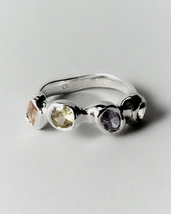 Prado Pepita Ring in silver: angled view of the ring's pale, green and purple stones.