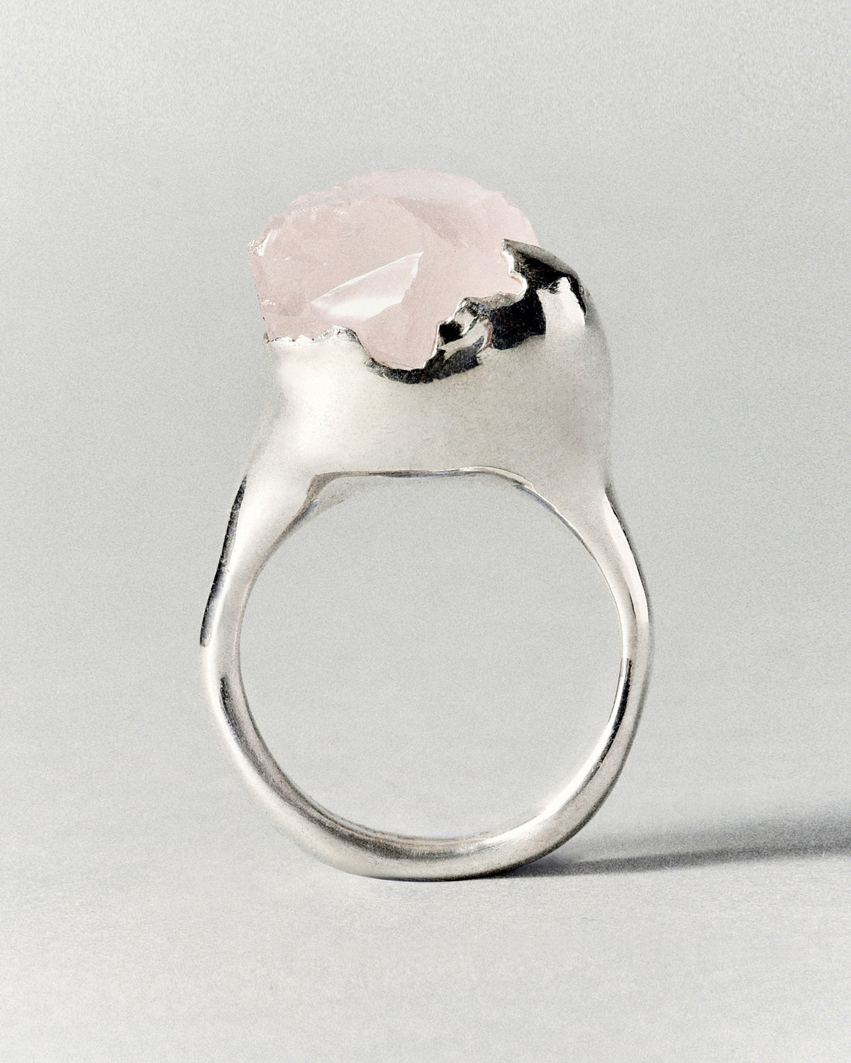Rose Ring in silver: side profile of the ring's pale pink rough stone.