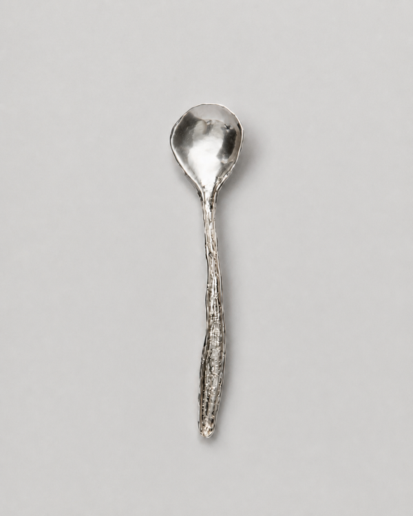 Spring Cutlery Spoon in silver: full view of a spoon with a textured organic handle.