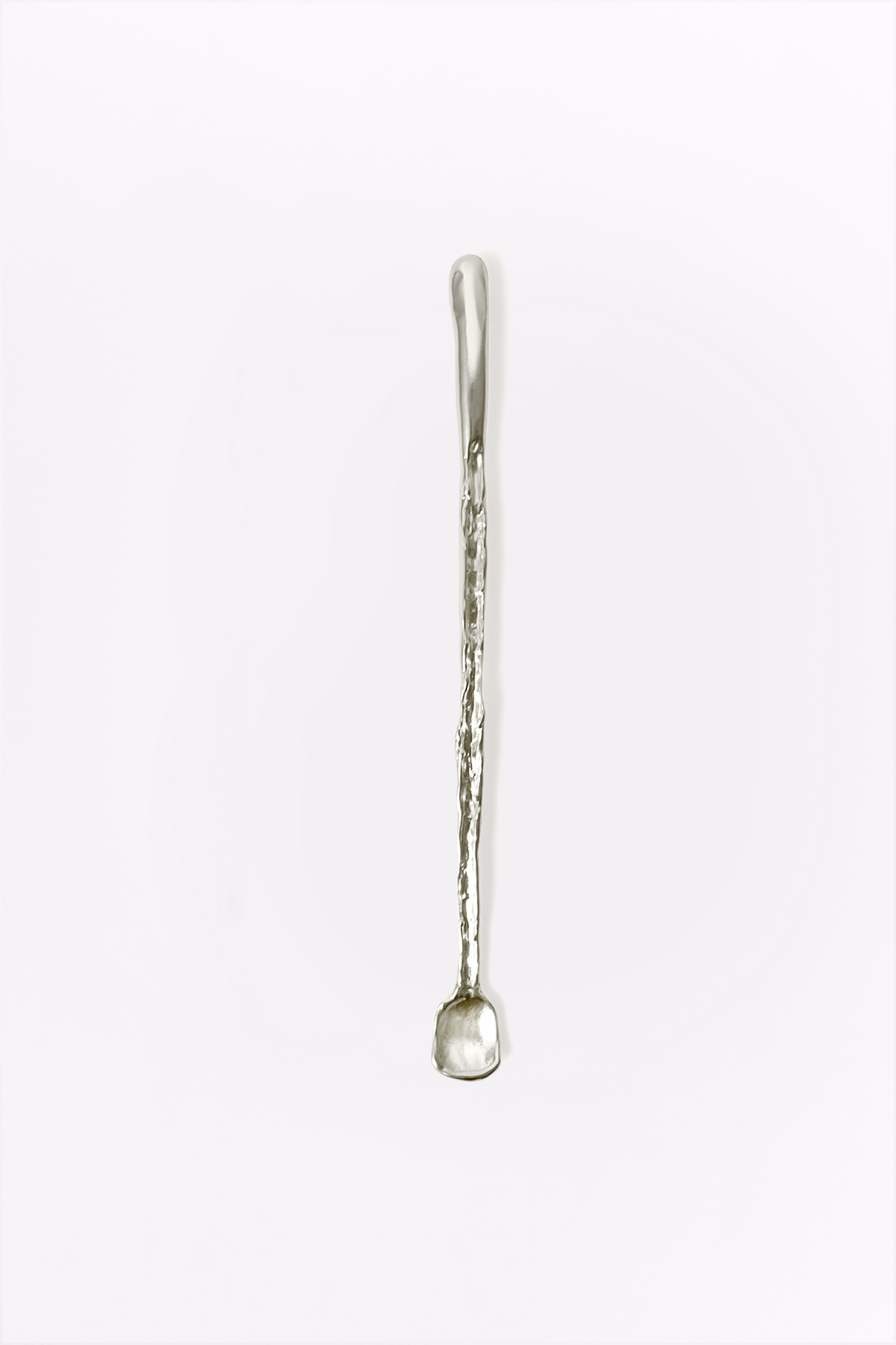 Spring Cutlery Stirring Stick in silver: full view of a slender textured stirring stick.