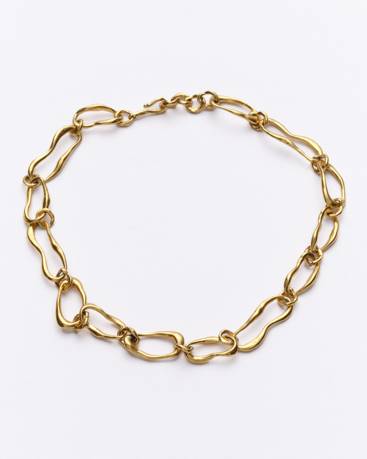 Sway Necklace in gold: full necklace showing irregular oval links on white.