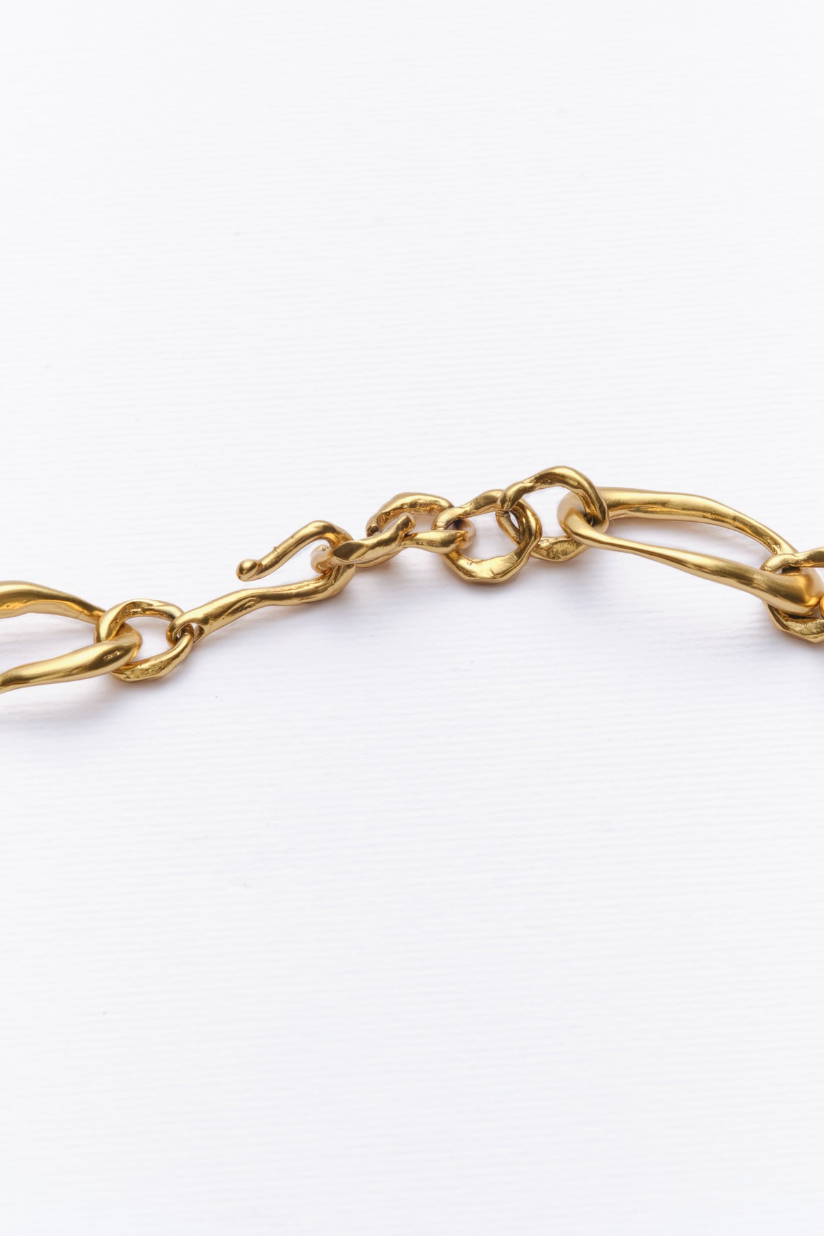 Sway Necklace in gold: close-up of the necklace's irregular oval links.