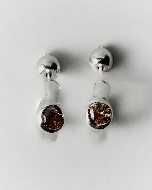 Tonka Mini Hoops in silver: pair of small sculptural hoops with reddish inset stones.