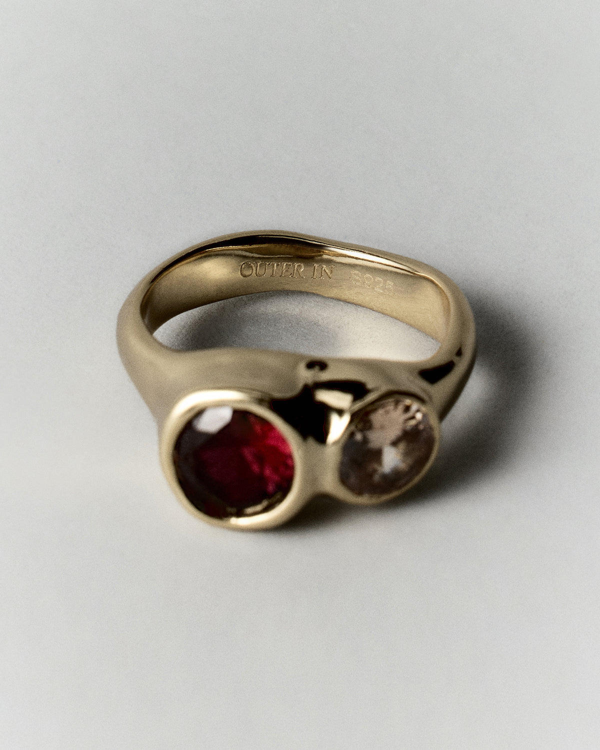 Tonka Ring in gold: angled view of the ring with red and amber-colored stones.