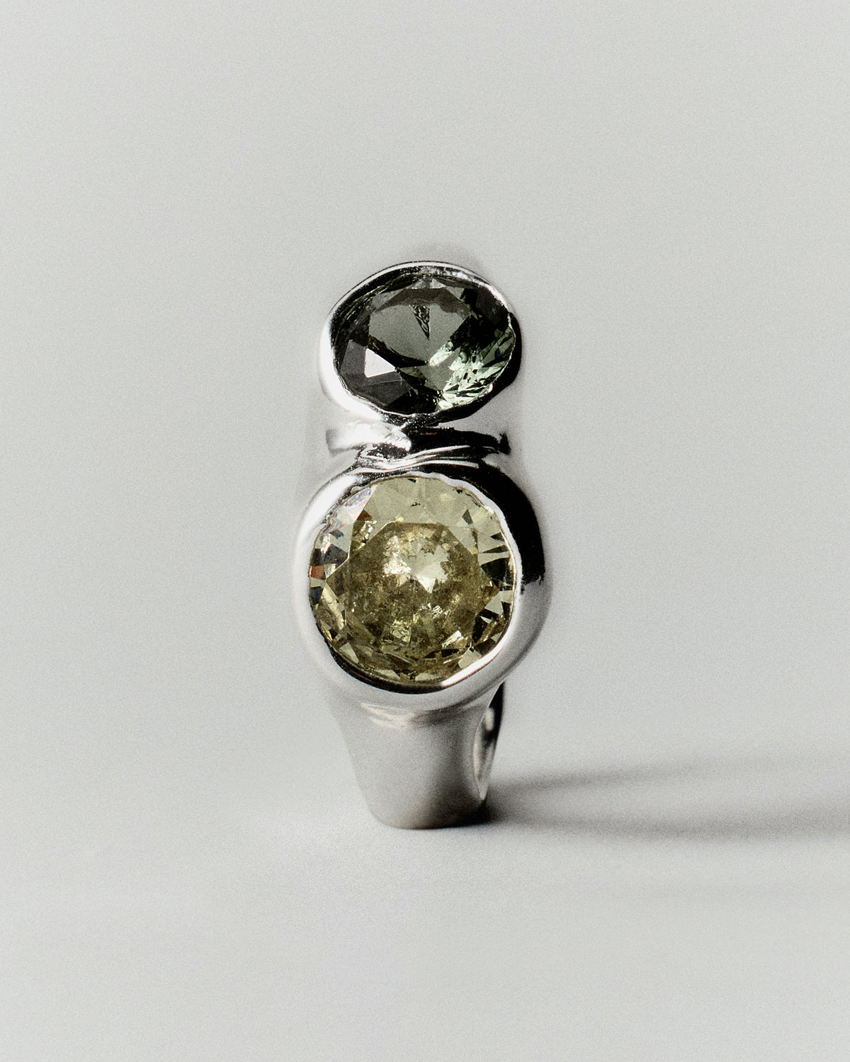 Tonka Ring in silver: ring standing upright with two pale green stone settings.