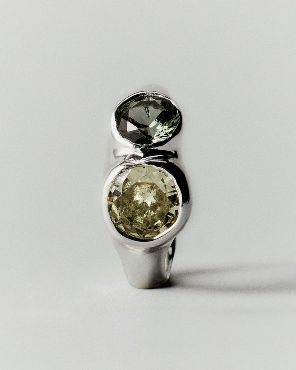 Tonka Ring in silver: ring standing upright with two pale green stone settings.
