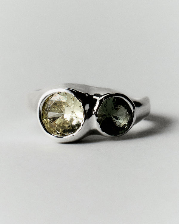 Tonka Ring in silver: front view of two contrasting green stones in smooth settings.