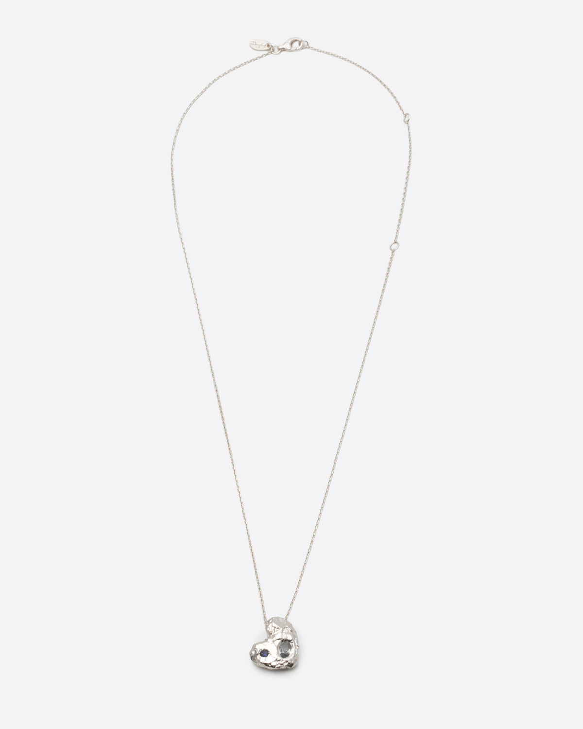 Vega Necklace in silver: full necklace showing the fine chain and small organic pendant.