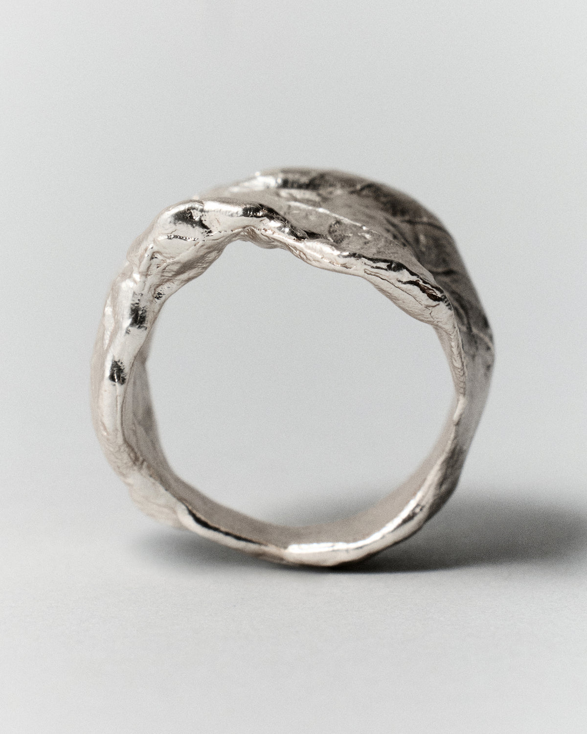 Vitalis Ring in silver: ring standing upright showing its irregular opening.