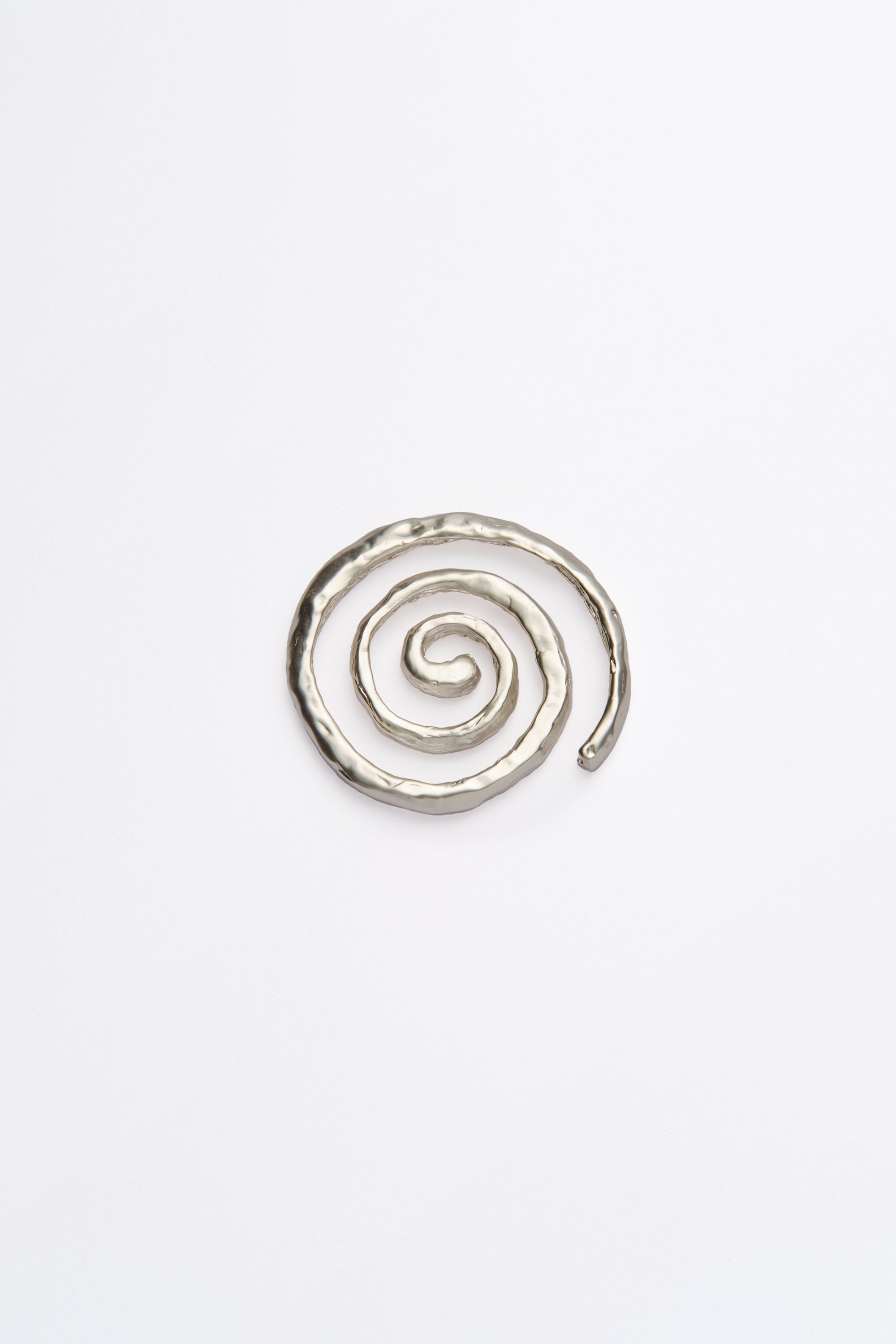A single spiral coaster with a silver finish on a white background.