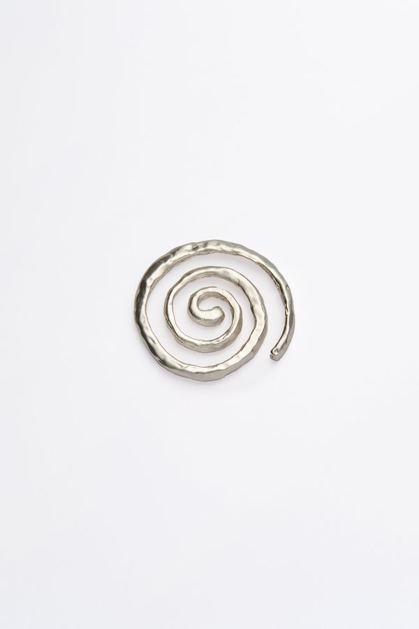 A single spiral coaster with a silver finish on a white background.