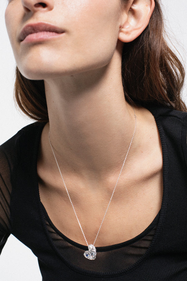 Silver solid heart pendant necklace with two stones worn on model