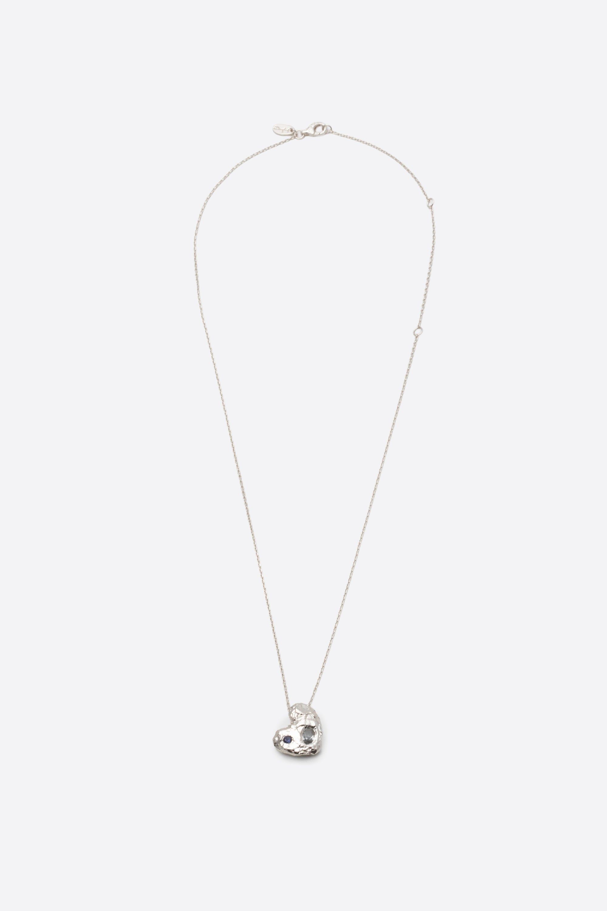 silver textured solid heart pendant necklace with two stones flat lay
